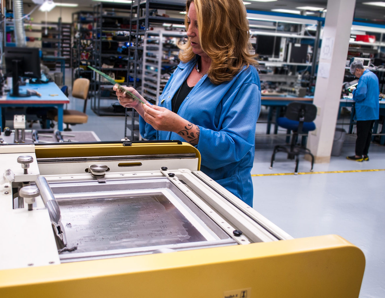 Woman examines soldering board